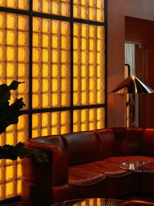 Art Deco lounge interior Riyadh Saudi Arabia   red leather sofa amber glass blocks chrome lamp