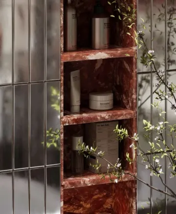 Red travertine shelving niche with slim glossy tiles and blossom branches   artisan tiling detail